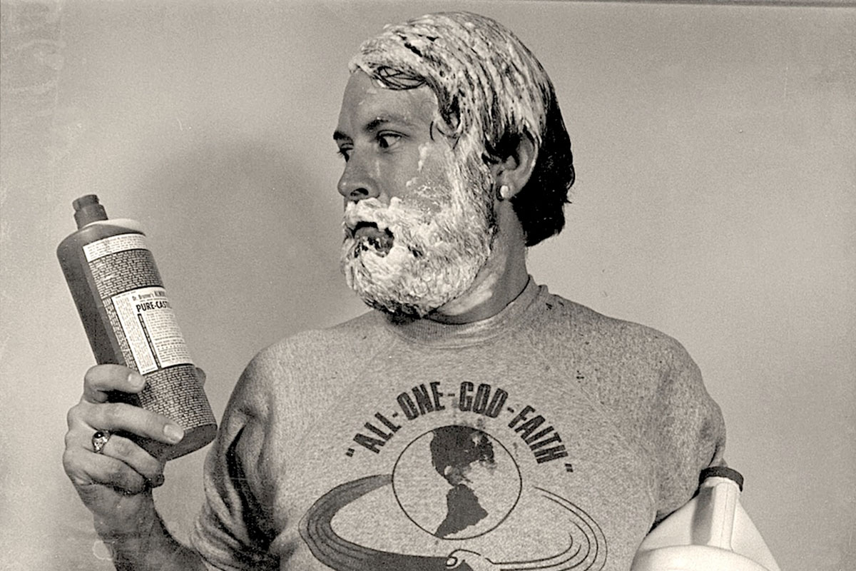 A man looking at a bottle of Dr. Bronner's soap. The company has been donating millions to the research of psychoactive substances