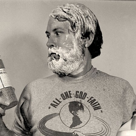 A man looking at a bottle of Dr. Bronner's soap. The company has been donating millions to the research of psychoactive substances