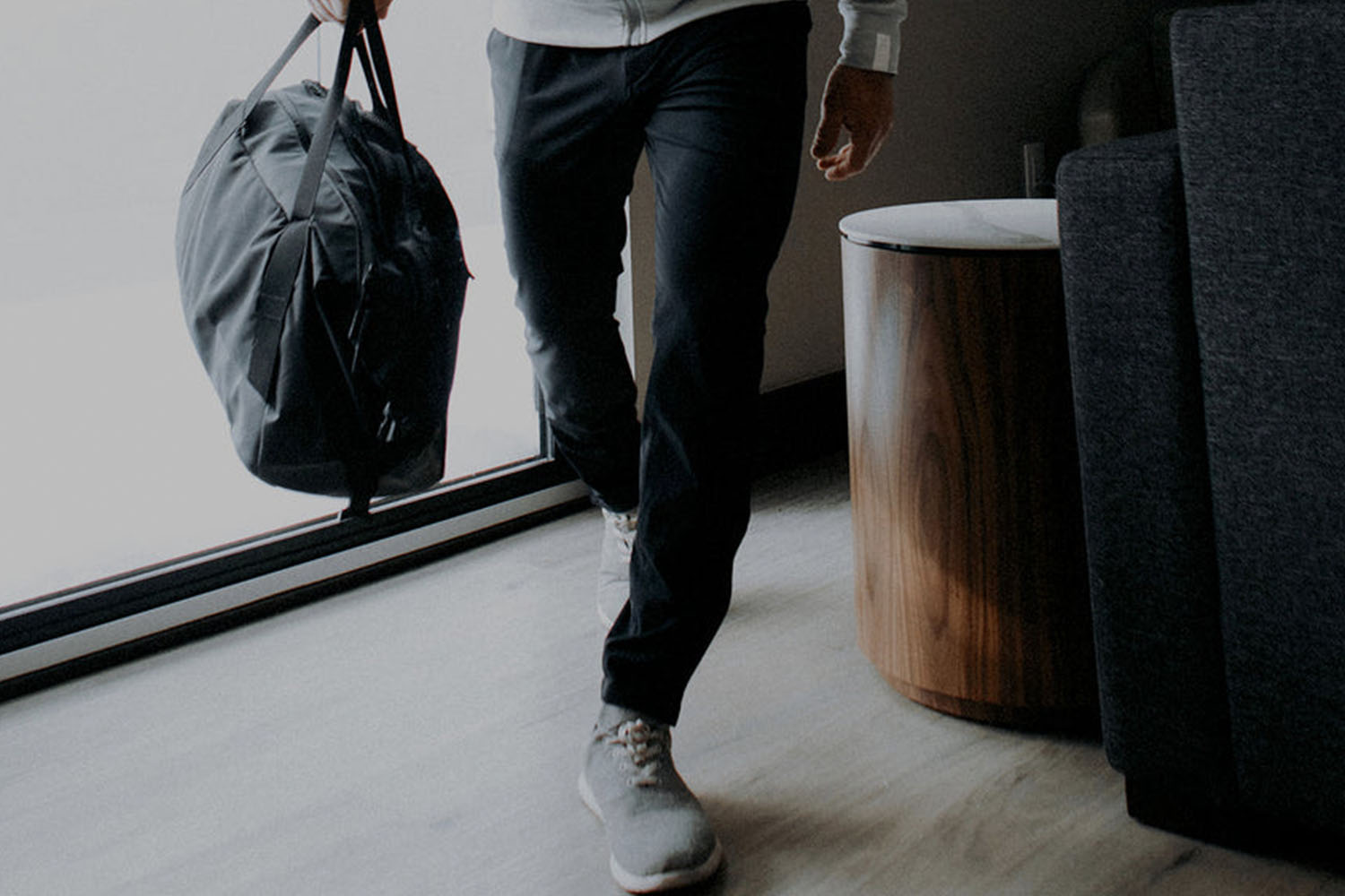 a model holding a briefcase in the CO1 ten thousand pants