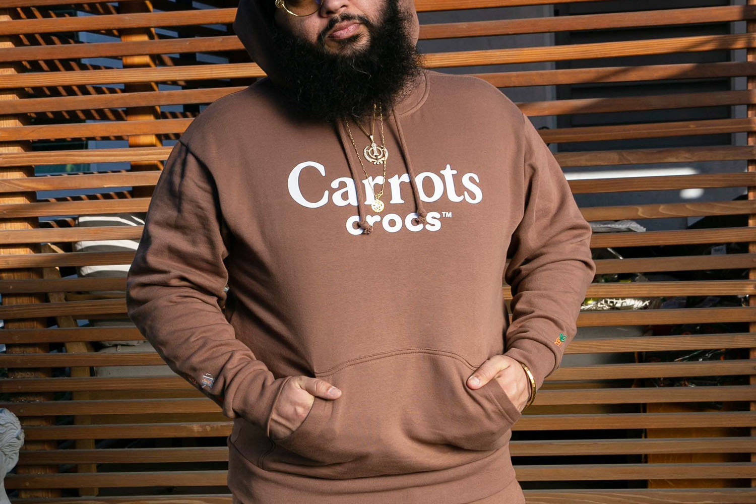 a brown hoodie wit ha co-branded logo