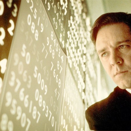 Man looks pensively at wall of data.