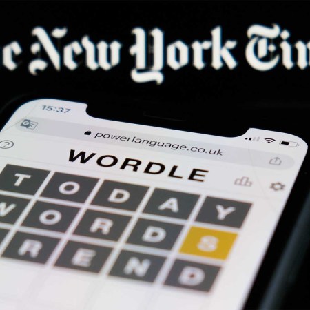 Wordle game displayed on a phone screen and The New York Times logo displayed in the background are seen in this illustration photo taken in Krakow, Poland on February 6, 2022