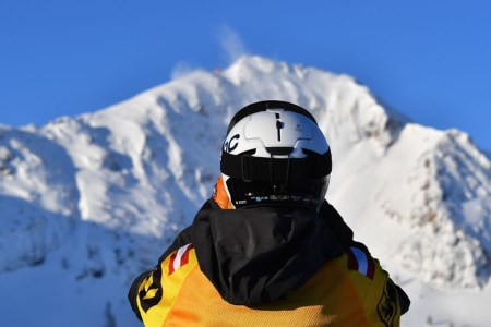 A competitor looks to the top of the mountain during the Freeride World Tour competition