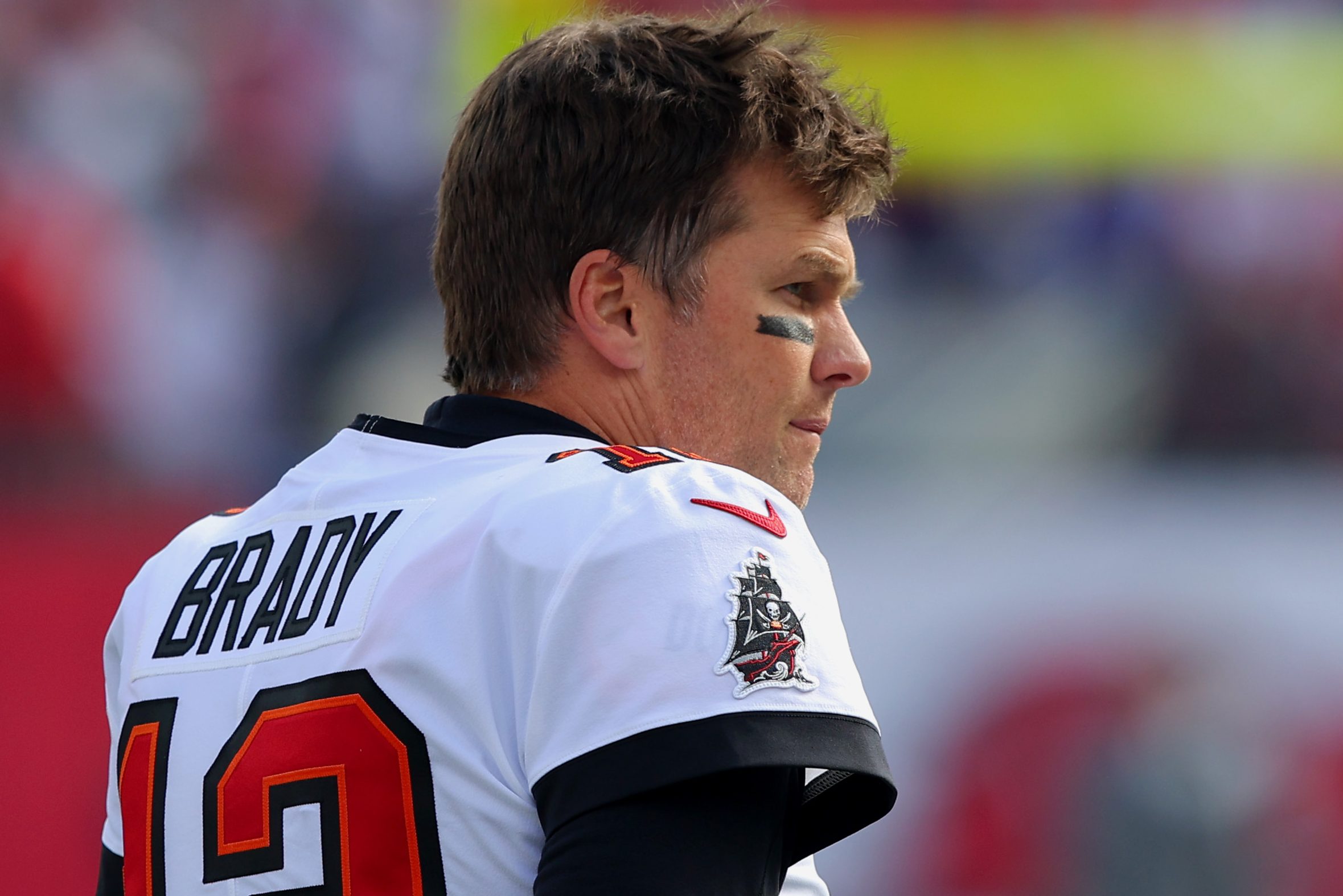 Tom Brady looks on before his final NFL game. The QB did not mention his former team, the Patriots, in his retirement annoucement