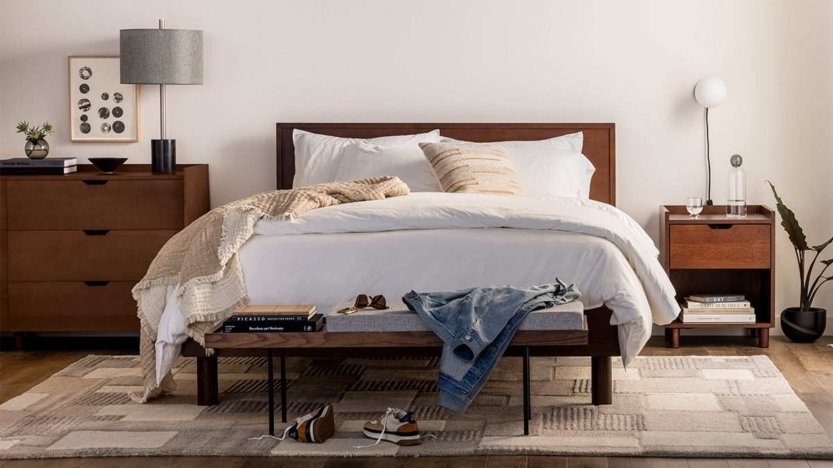 The Burrow Circa Bed with a headboard and a dark walnut finish. The DTC furniture company launched this Bedroom collection in February 2022.