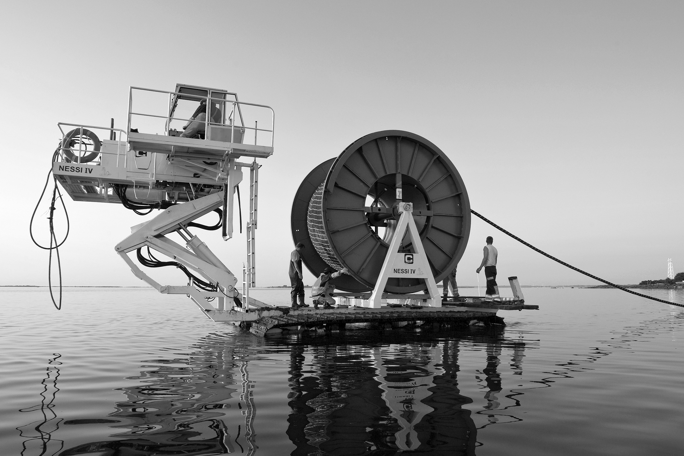 A teams lays an undersea cable to Hiddensee Island in the Baltic Sea