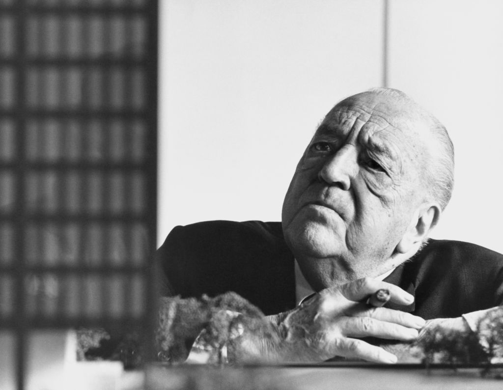 Architect Mies van der Rohe in a black and white photograph. In the 1950s, he designed a frat house. In 2022, that design opened at Indiana University.