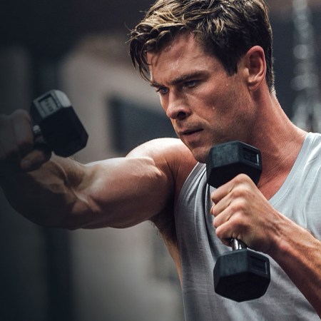 Chris Hemsworth holding dumbbells.