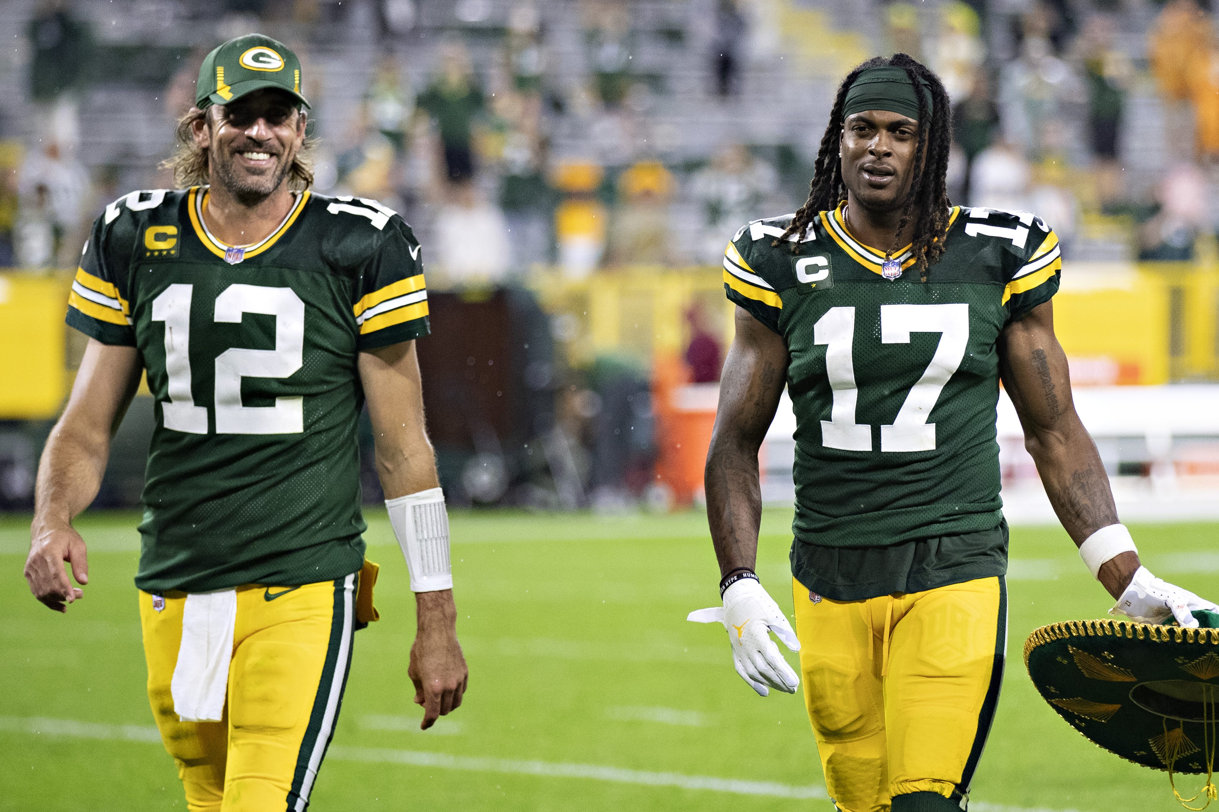 Aaron Rodgers and Davante Adams of the Green Bay Packers walk off the field together