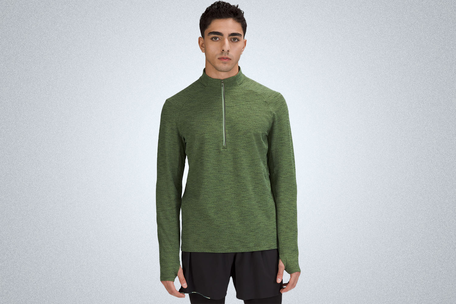 a model in a green half zip