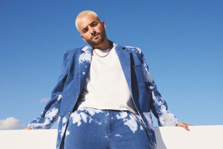 Maluma standing in front of a blue sky