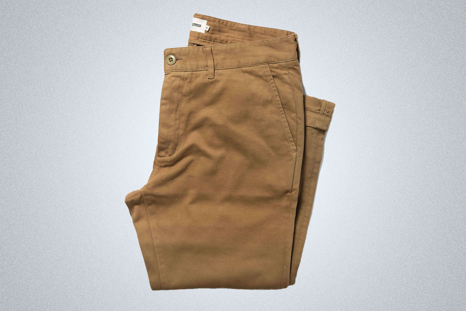 a pair of chinos on a grey background