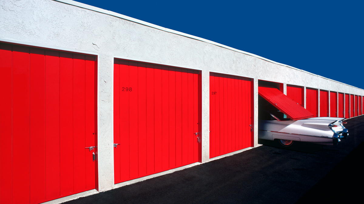 A classic limousines disappears into a storage unit