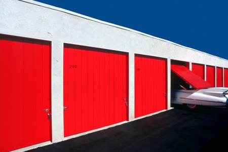 A classic limousines disappears into a storage unit