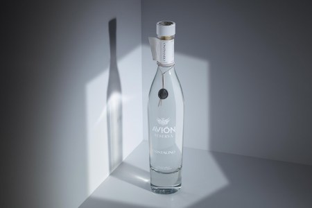 a bottle of Avión Reserva Cristalino, in shadows