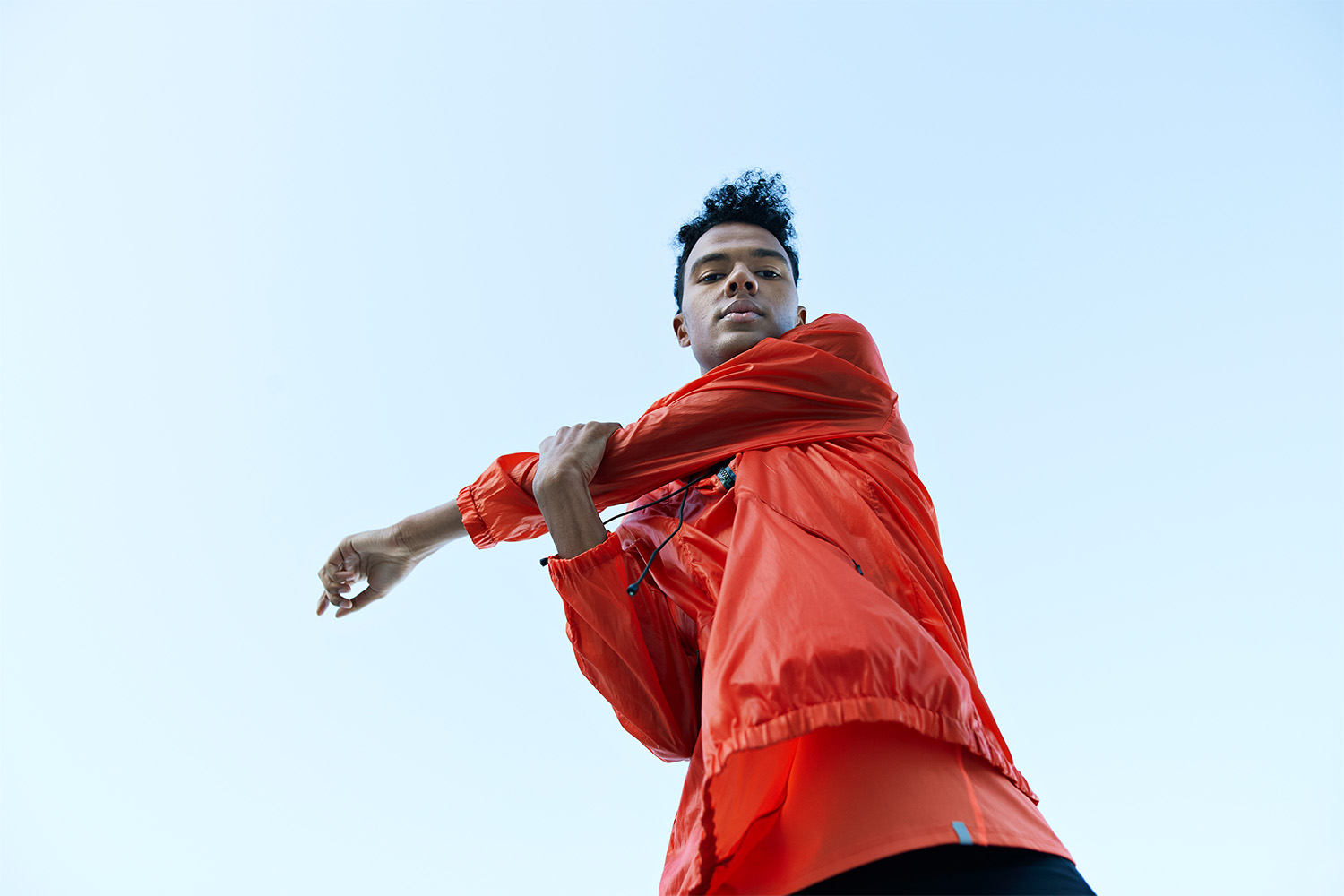 Man stretching in red shirt