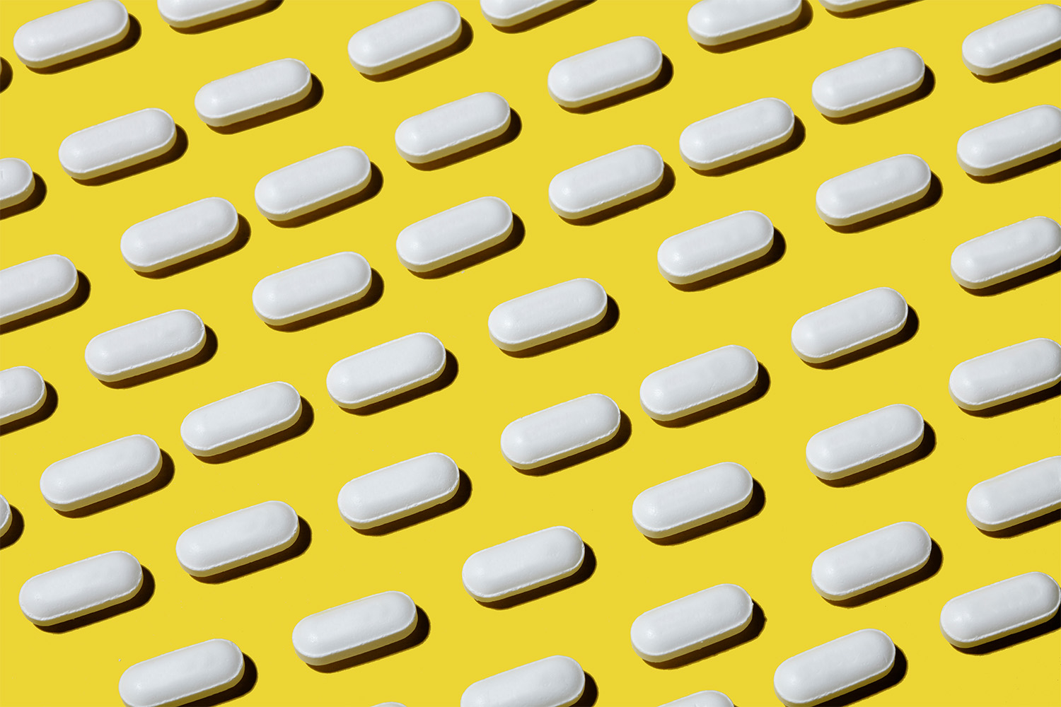 white pills on yellow background