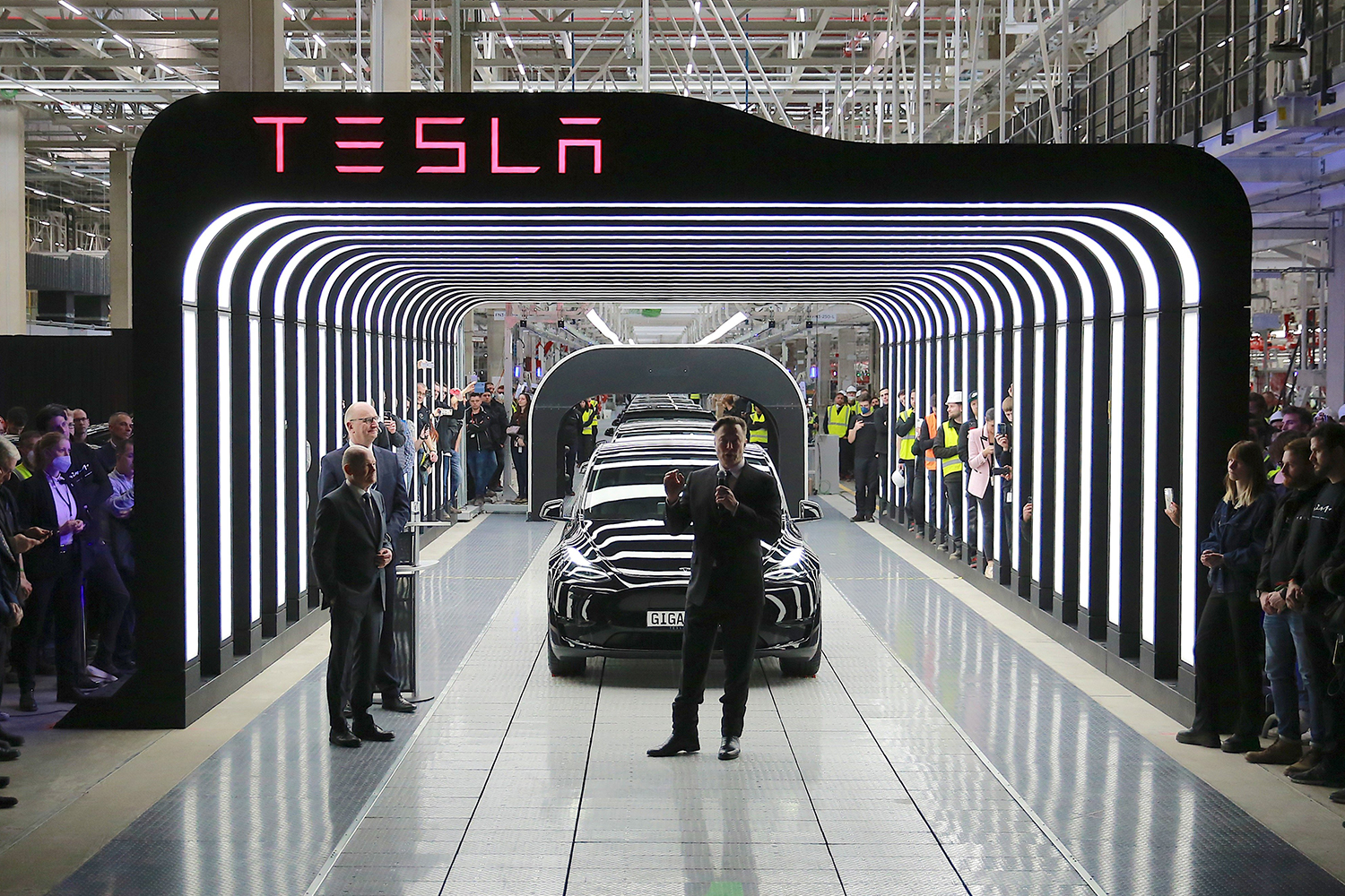 Tesla CEO Elon Musk stands in front of a line of Model Y vehicles during the opening of the EV company’s German factory Giga Berlin on March 22, 2022.