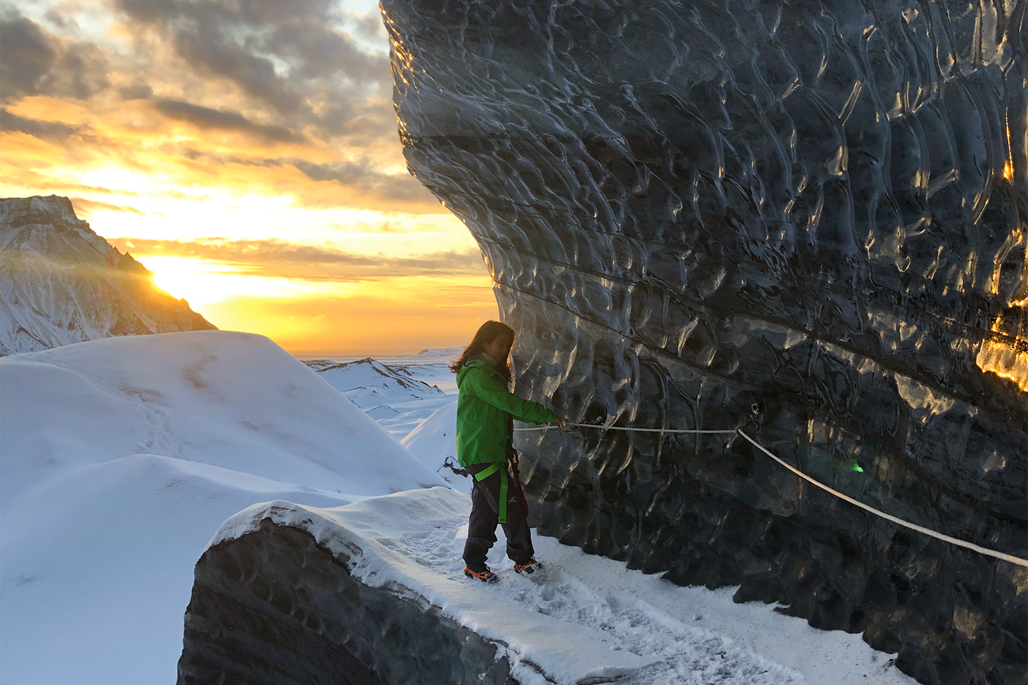 A woman hiking on a glacier in Iceland. We put together an itinerary for those looking to visit Iceland in the off-season.