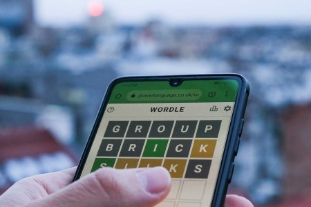 A person playing the daily word game Wordle on their phone. A new study reveals which states cheat at Wordle the most.