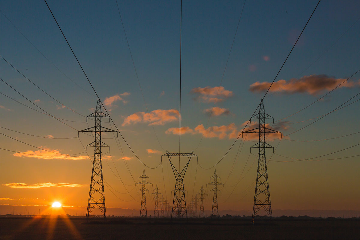 Power lines against a colorful sky.