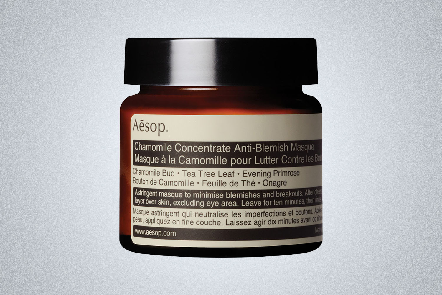 a Aesop skincare product on a grey background