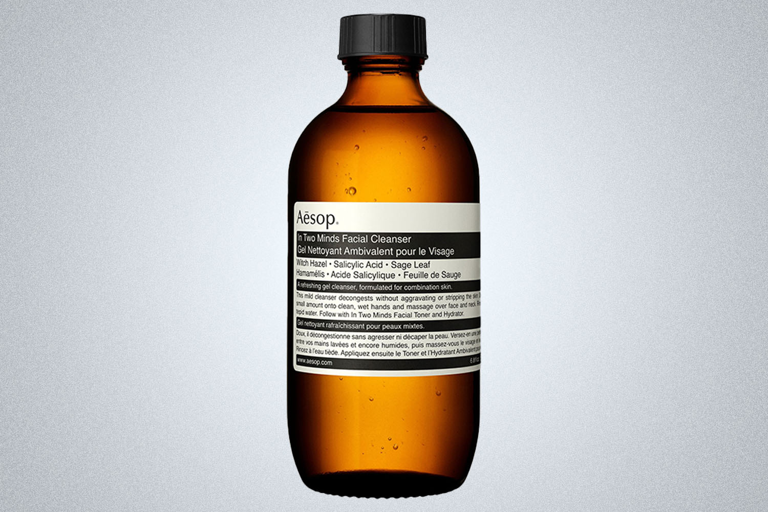 a Aesop skincare product on a grey background