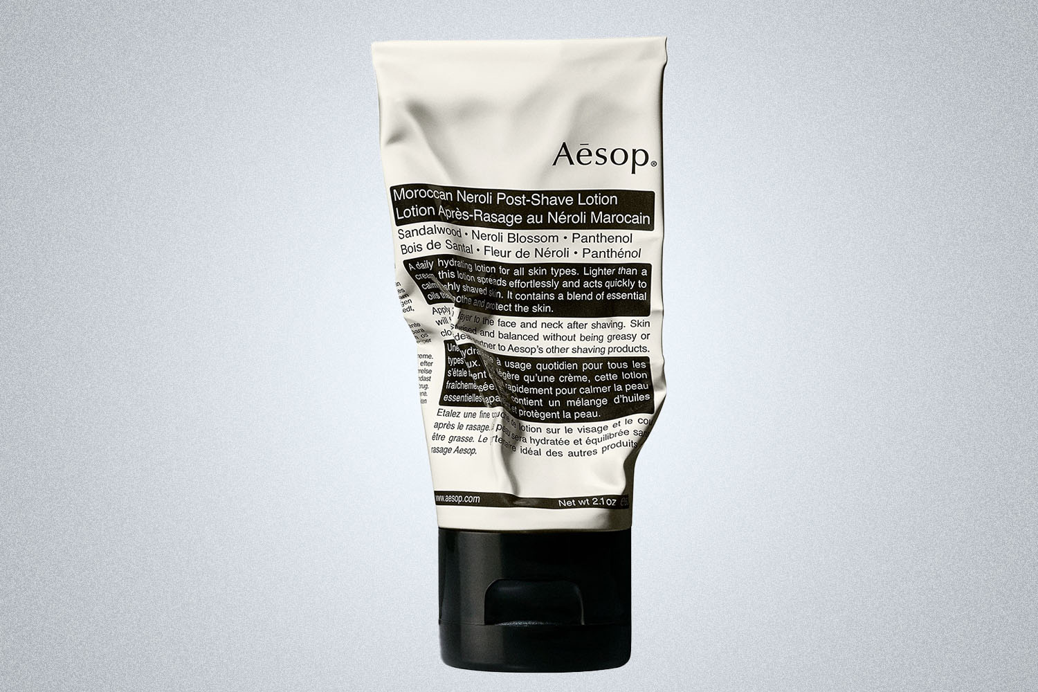 a Aesop skincare product on a grey background