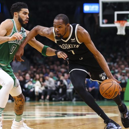 Kevin Durant of the Brooklyn Nets drives to the basket past Jayson Tatum of the Boston Celtics