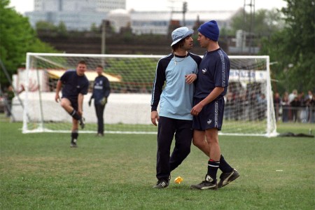 Two musicians bodying up on a soccer field