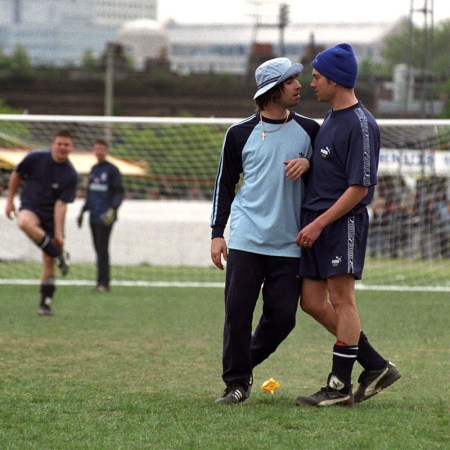 Two musicians bodying up on a soccer field