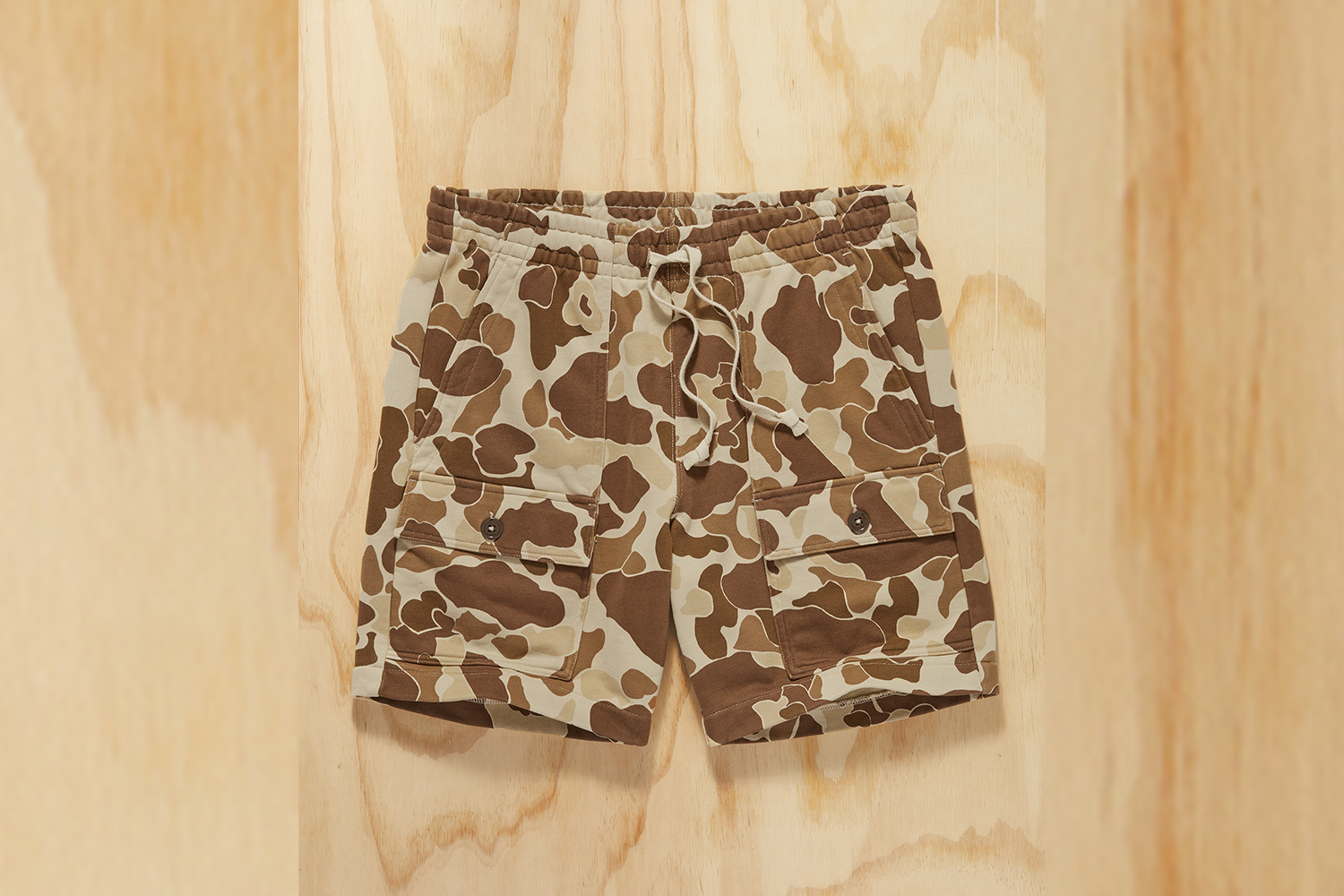 a pari ocamo sweatshorts on a wood background