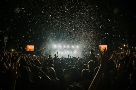 An indoor shot of a crowded concert. Recent online debate has centered on people talking during concerts.