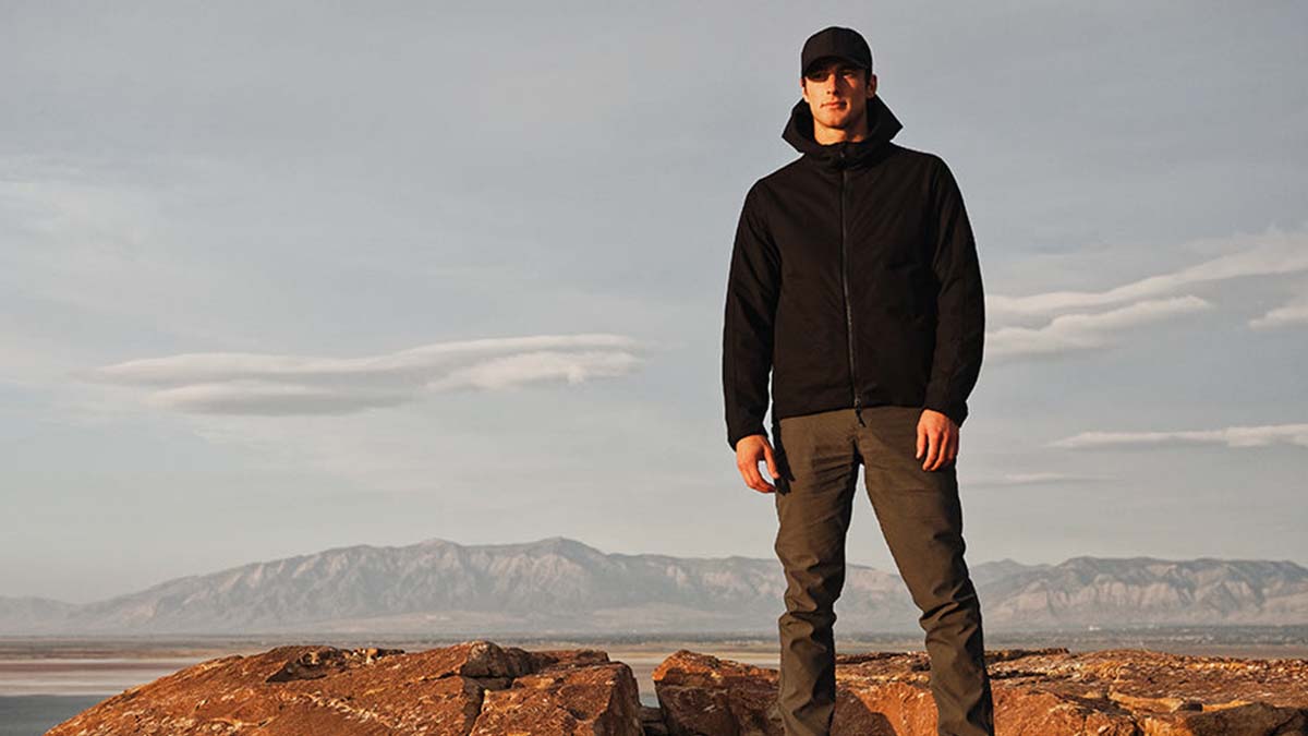 A man in Western Rise gear on top of a mountain. Western Rise is one of 13 eco-friendly brands hosting a one-day sale in honor of Earth Month.