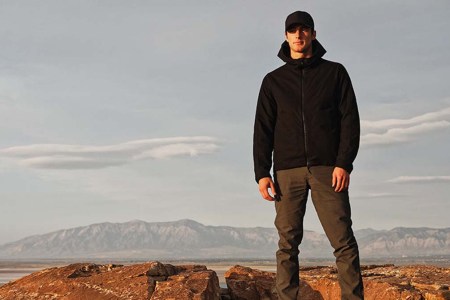 A man in Western Rise gear on top of a mountain. Western Rise is one of 13 eco-friendly brands hosting a one-day sale in honor of Earth Month.