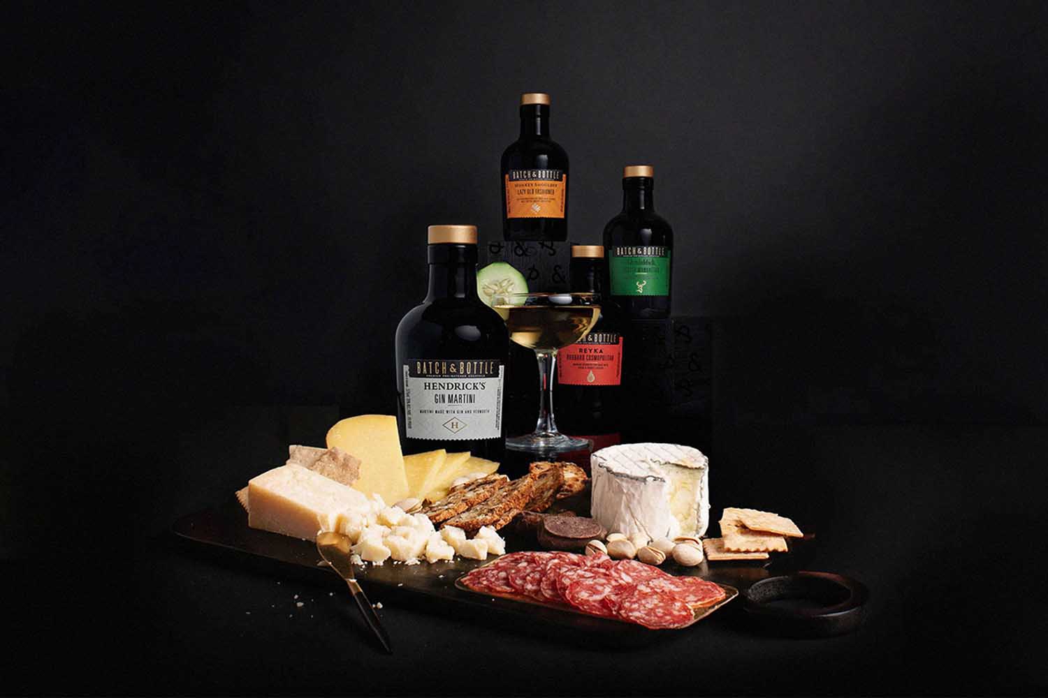 a collage of bottle and charcuterie fair on a black background