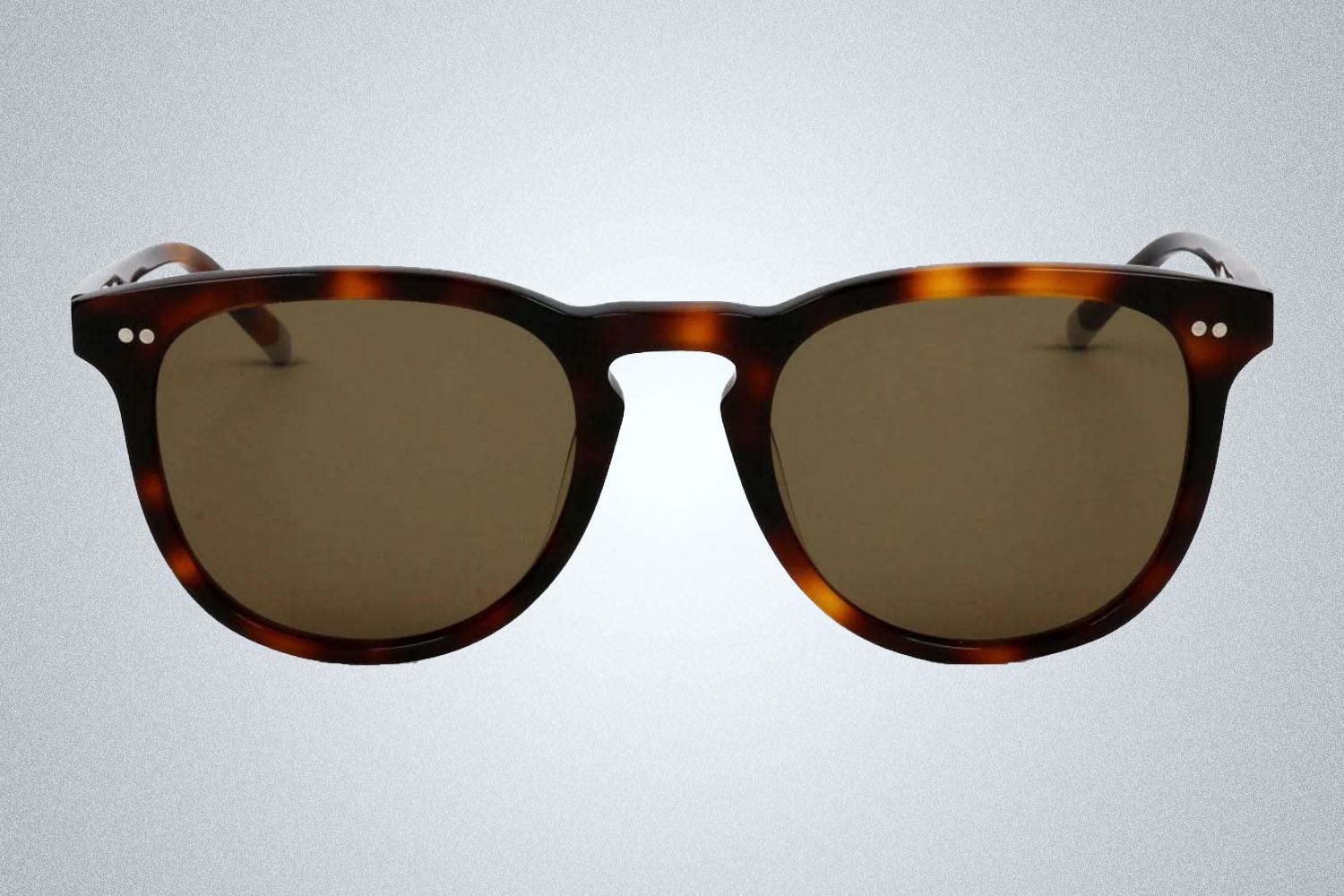 A pair of sunglasses from GlassesUSA on a grey background