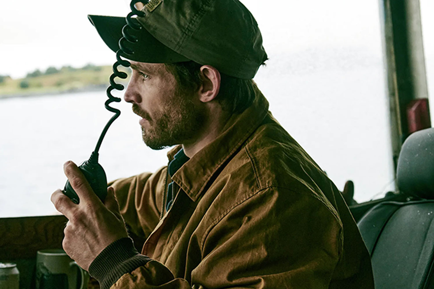 A man in a Filson jacket in a truck