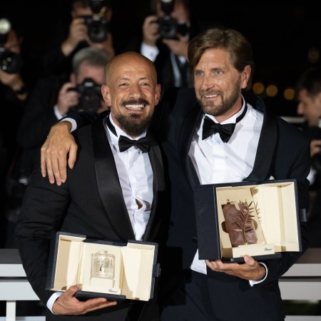 Ruben Ostlund (R) with the Palme D'or Award for "Triangle of Sadness" and Tarik Saleh (L) with the Best Screenplay Award for "Boy from Heaven" pose for a photo during the winner photocall during the 75th annual Cannes film festival.