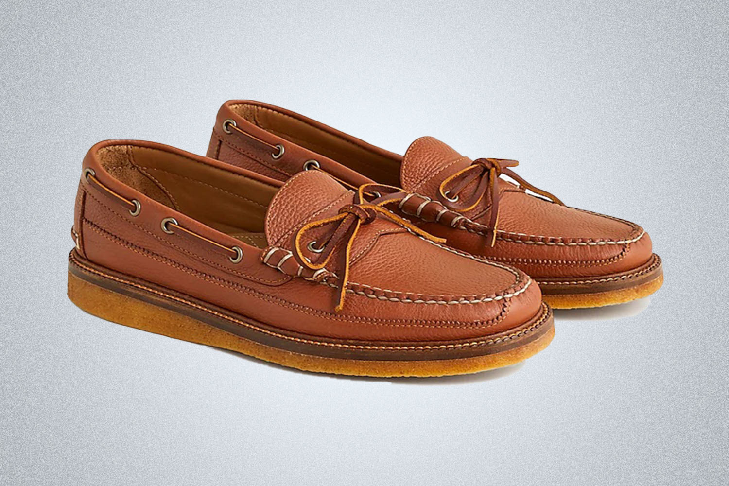 a pair of leather brown J.Crew slip ons on a grey background