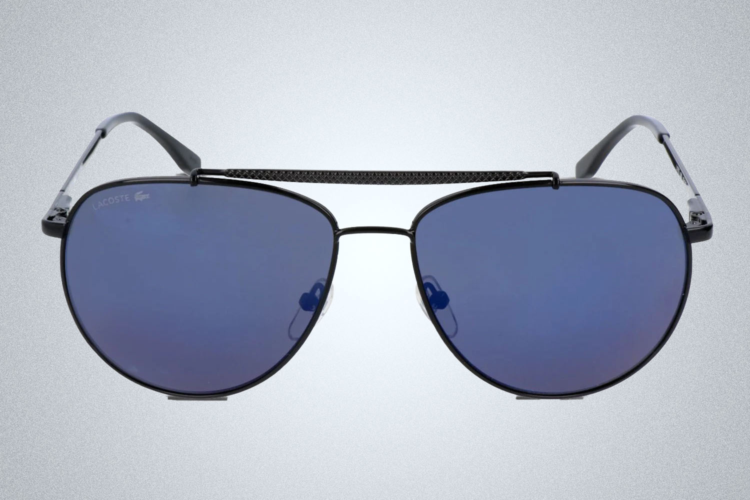 A pair of sunglasses from GlassesUSA on a grey background