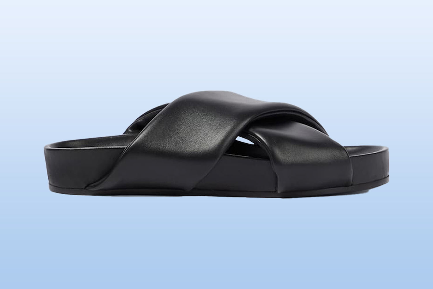 a black leather sandal from mytheresa on a light blue background