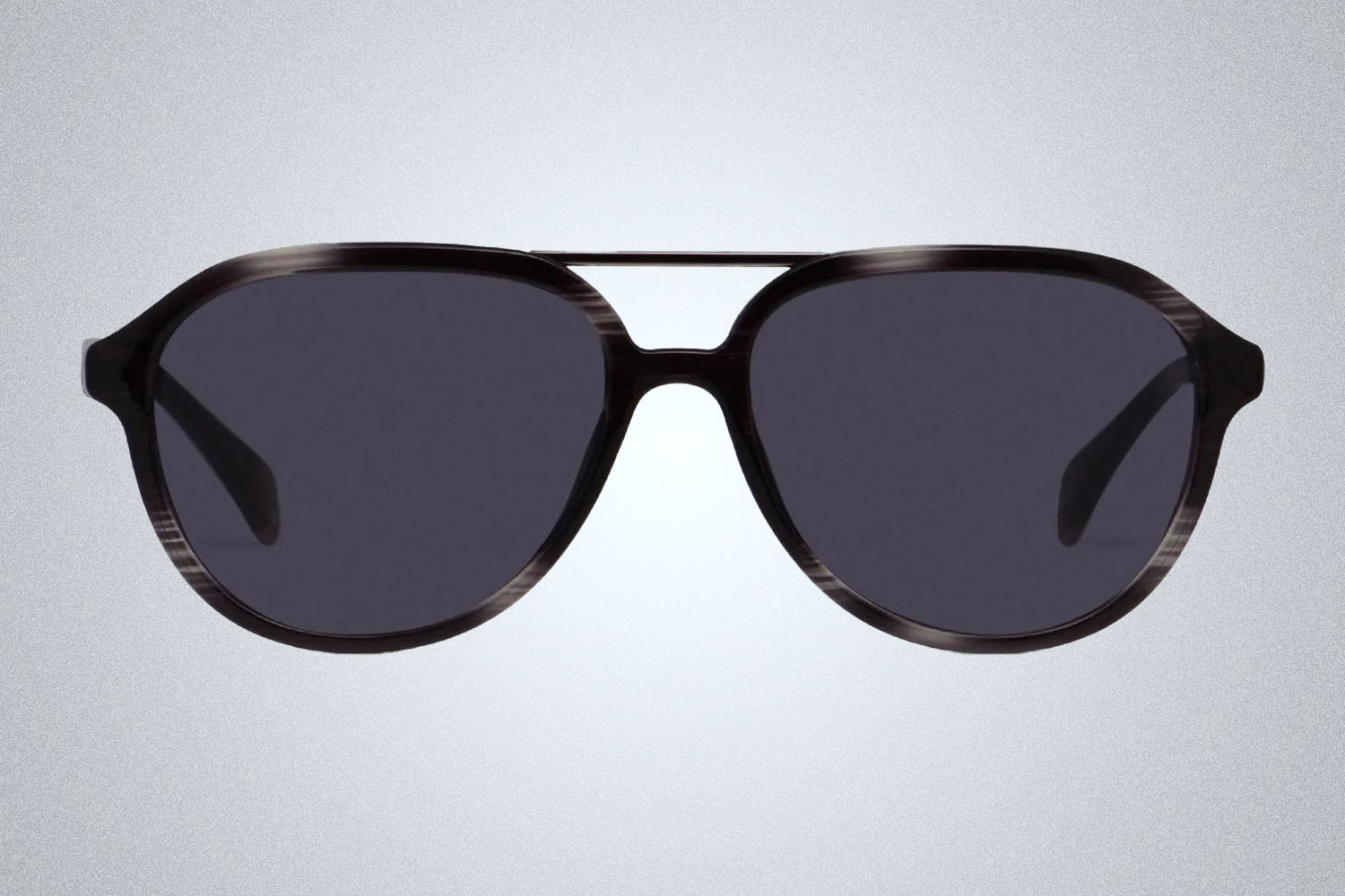 A pair of sunglasses from GlassesUSA on a grey background