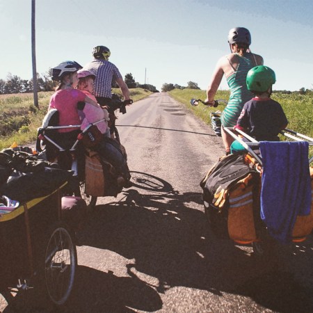 Parents hauling their kids on cargo bikes