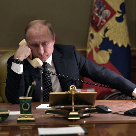 Russian President Vladimir Putin speaks on the phone in his office in Saint Petersburg on December 15, 2018