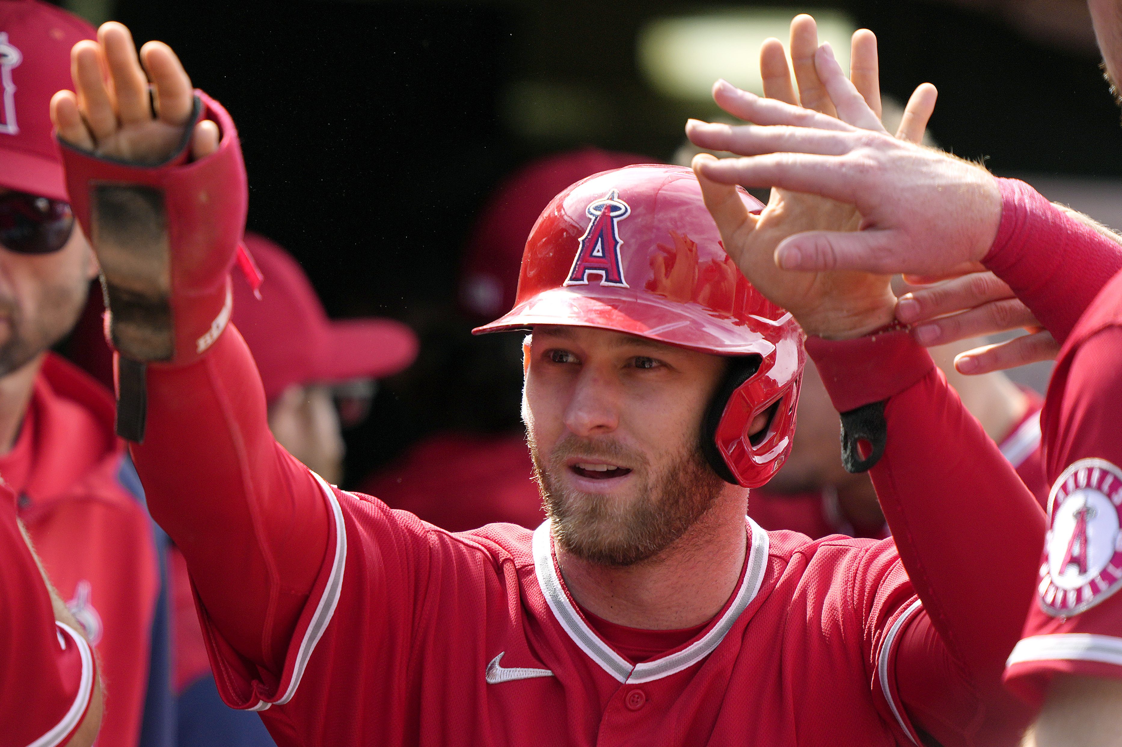 Taylor Ward of the Los Angeles Angels is congratulated by his teammates after scoring