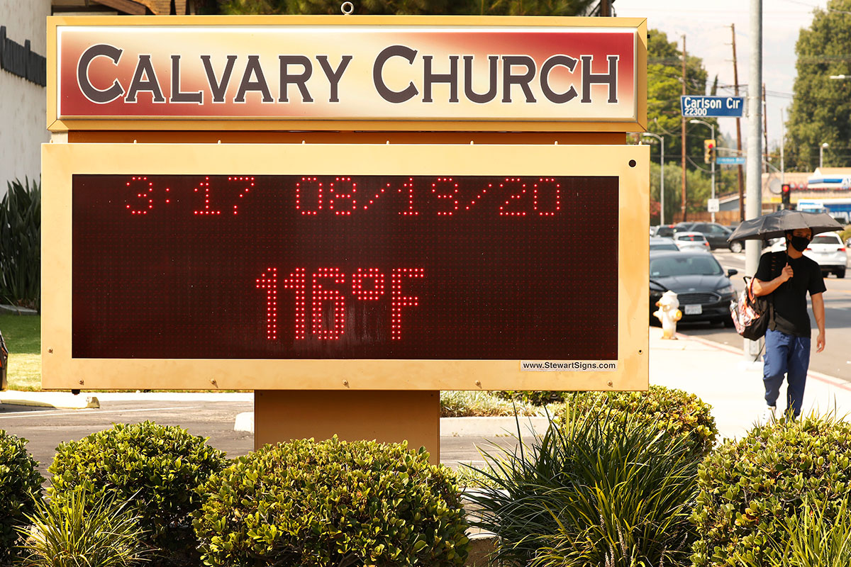 A man walks past a church during a heatwave.