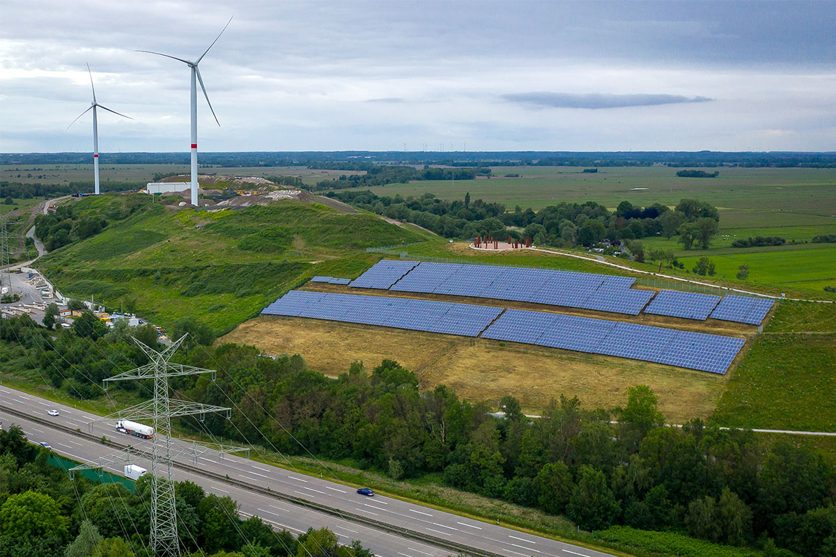 A solar-paneled landfill on a grassy hill.