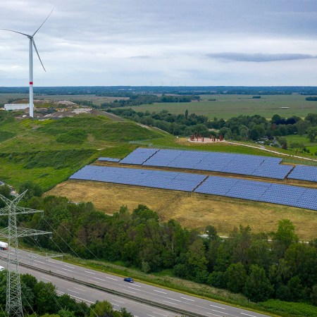 A solar-paneled landfill on a grassy hill.