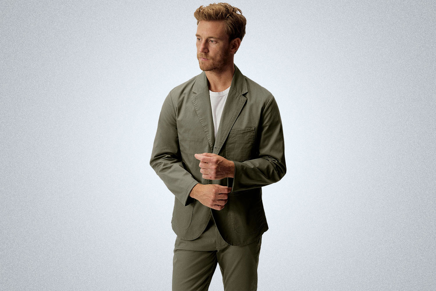 a model in the Buck Mason Carry-On Suit on a grey background